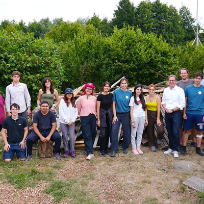 Bild vergr&ouml;&szlig;ern: Internationales Workcamp: Gruppenfoto Holzhaufen